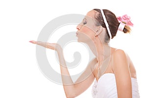 Woman bride in white wedding dress blowing a kiss.