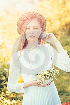 Woman bride in white wedding dress. Sensual woman in wreath on long blond hair. Albino girl with camomile daisy flowers