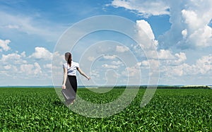 Woman with a briefcase walking on grass