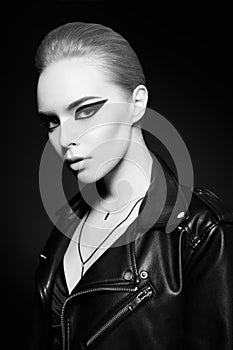 Woman with bright makeup in leather jacket