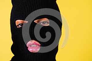 Woman with bright pink lips, balaclava on her head