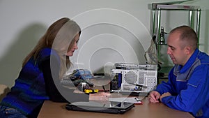 woman bring broken laptop to computer repair specialist. Computer maintenance.