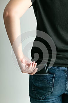 A woman bring out money wallet from jeans pocket