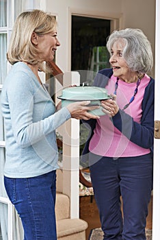 Woman Bringing Meal For Elderly Neighbour