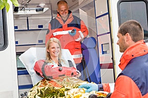 Woman with broken arm in ambulance paramedics photo