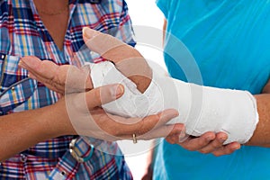 Woman with a broken arm and her caregiver