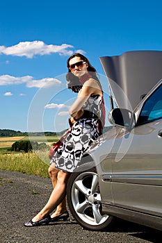Woman by broken down car