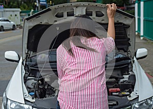 Woman and broken down car on road checking problem in engine. Accident and breakdowns with auto concept