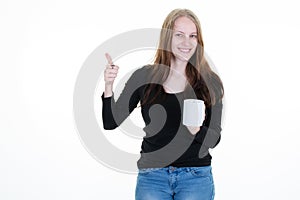 Woman with brown cardboard cup of coffee and pointing thumbs up with blank space aside