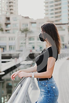 Woman with brown hair wearing reusable protective face mask