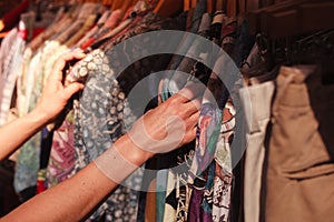 Woman browsing clothes at market