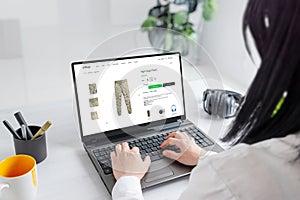 Woman browsing online for cargo pants, exploring stylish options and finding the perfect fit for her wardrobe photo