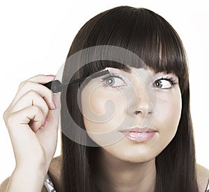 Woman brunette applying make up mirror reflection