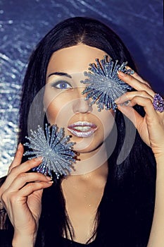 Woman brunette with Christmas decorations silver snowflakes.