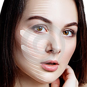 Woman brunette graphic lines shows facial lifting effect.