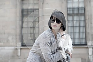 Woman with brunette hair, red lips, makeup, beauty. Sensual woman in sunglasses pose in paris, france, fashion. Fashion