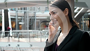 Woman brunette with phone smiling close up portrait. Young business woman professional happy. Beautiful multiethnic