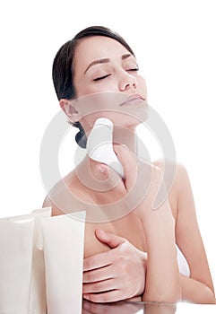 Woman with brush for deep cleansing facial.