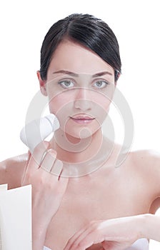 Woman with brush for deep cleansing facial.