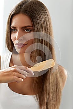 Woman Brushing Beautiful Healthy Long Hair With Brush Portrait