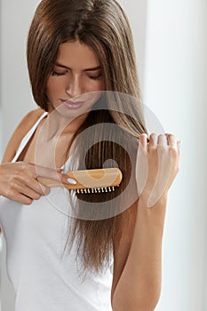 Woman Brushing Beautiful Healthy Long Hair With Brush Portrait