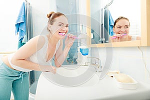 Woman brushing cleaning teeth. Oral hygiene.