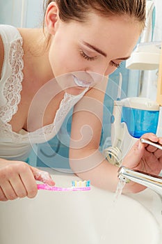 Woman brushing cleaning teeth. Oral hygiene.