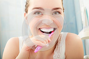 Woman brushing cleaning teeth. Oral hygiene.