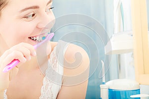 Woman brushing cleaning teeth. Oral hygiene.