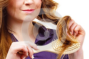 Woman brushing long healthy brown hair