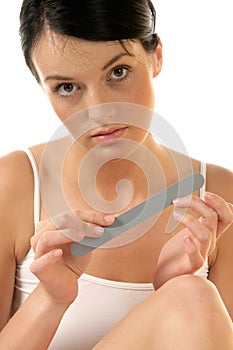 Woman buffing her nails photo