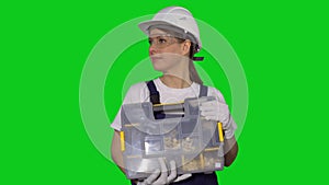 Woman builder in blue overalls and white hard hat helmet with toolbox.