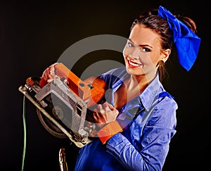 Woman in builder clothers holding circular saw