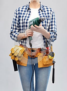 Woman or builder with drill and work tools