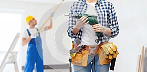 Woman or builder with drill and work tools