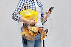 Woman or builder with phone and working tools