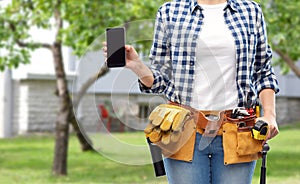 Woman or builder with phone and working tools