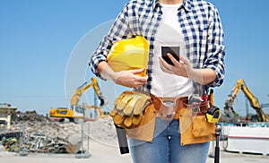 Woman or builder with phone and working tools