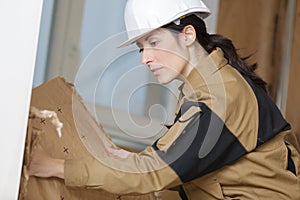 Woman builder removing part wall