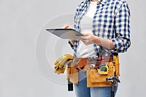 Woman or builder with tablet pc and working tools