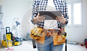 Woman or builder with tablet pc and working tools