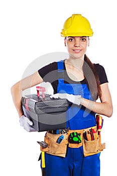 Woman builder in the uniform holds a tool box