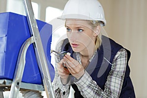 woman builder working with electronics