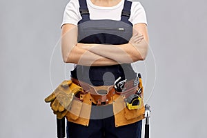 Woman or builder with working tools on belt