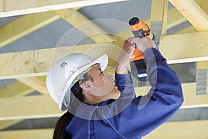 woman builder working on wooden structures