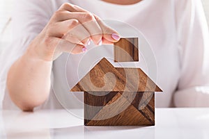 Woman Building House With Wooden Tangram Puzzle