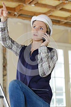 woman on building site using smartphone