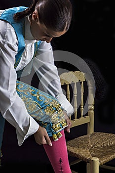 Woman bullfighter by dressing with vest