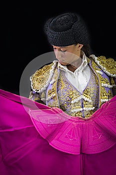 Woman bullfighter holding capote pink