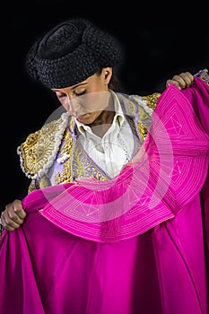 Woman bullfighter holding capote pink photo